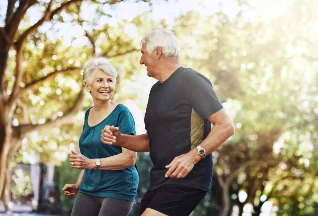Active retired couple enjoying financial freedom and healthy living after retirement planning with Endeavr Wealth.