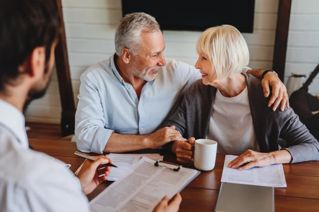 Financial advisor meeting with retired couple in Minnetonka to review retirement planning documents.